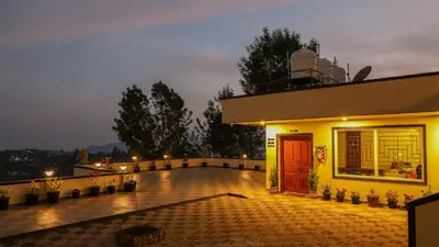 a house with a red door on a balcony at Aira Residency Kothagiri by Lexstays in Kotagiri