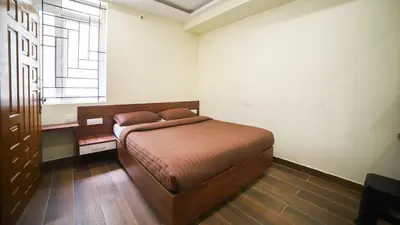 a bedroom with a bed in a room with a window at Aira Residency Kothagiri by Lexstays in Kotagiri