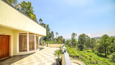 a house with a porch with a checkered floor at Aira Residency Kothagiri by Lexstays in Kotagiri