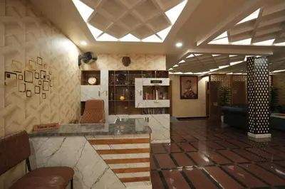 a lobby of a hotel with a bar and a couch at Hotel Kairali in Palakkad