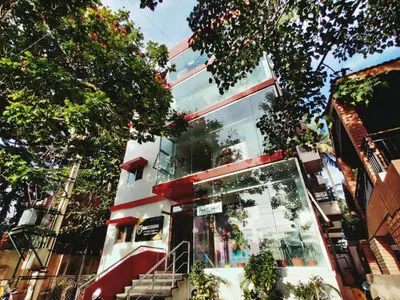 a building with stairs in front of it at Raccoon Rooms in Mysore