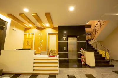 a room with a staircase and a stair case at Ponnis Hotel in Palani