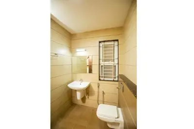 a bathroom with a toilet and a sink at Ponnis Hotel in Palani