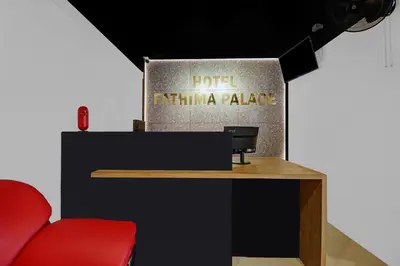 a booth at a hotel exhibit with a red chair at Hotel Fathima Palace in Kottakkal