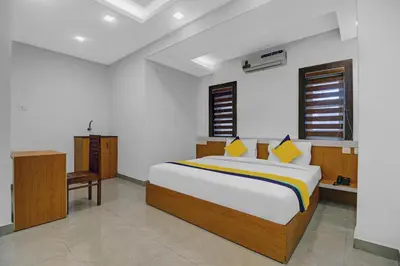 a bedroom with a large bed in a room at Hotel Fathima Palace in Kottakkal
