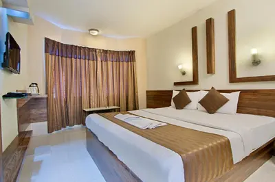 a bedroom with a large bed in a room at Mannars Residency in Mysore