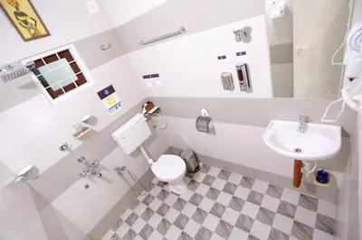 a bathroom with a toilet and a sink at Base9 Cochin Airport Hotel in Nedumbassery