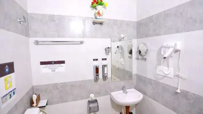 a bathroom with a sink and a mirror at Base9 Cochin Airport Hotel in Nedumbassery