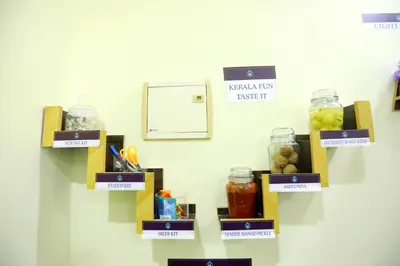 a wall with shelves with jars of food at Base9 Cochin Airport Hotel in Nedumbassery