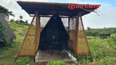 a tent with a table and chairs in it at Shining Caves Resort in Varagampadi