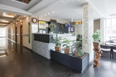 a lobby of a restaurant with potted plants at FabHotel Prime Suloka Towers - 500m from View point, Kaveri River in Kushālnagar