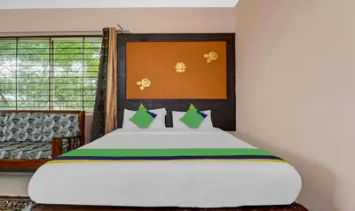 a bedroom with a large white bed and a window at GRAND JP INN Near 2 km from Gundlupet bus stand in Gundlupet
