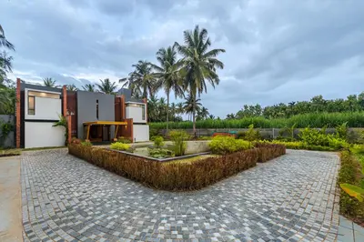 a villa with a courtyard in a resort at SaffronStays Riverstone 3-BR Riverside Villa with Farm Views in Seringapatam