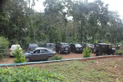 a bunch of cars parked in a parking lot at Coorg amodhini in Madikeri