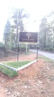 a sign on the side of a road at Coorg amodhini in Madikeri