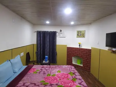 a bedroom with a bed with flowers on it at Heritage Holiday Home in Ooty