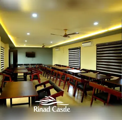 a dining room with wooden tables and chairs at Royal Plaza Wayanad in Vythiri