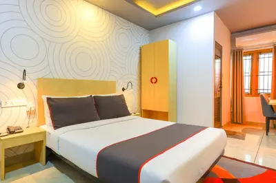 a bedroom with a large bed in a room at Collection O Marhaba Govindapuram in Calicut