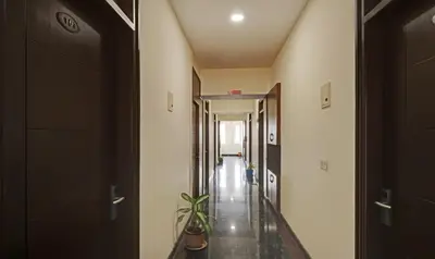 a hallway with a plant in a room at Treebo RJ Residency in Mysore