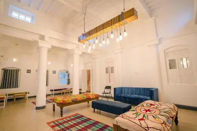 a large room with a couch and chairs in it at Roambay in Mysore
