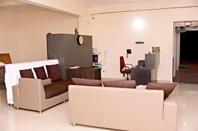 a living room with a couch and a chair at The INN in Mysore