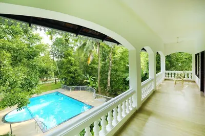 a house with a swimming pool on a balcony at Once Upon The River, Aluva - Near Cochin International Airport in Cochin