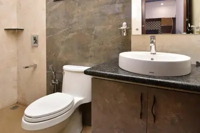 a bathroom with a white toilet and a sink at Villa Hugel ooty By StayVista in Ooty