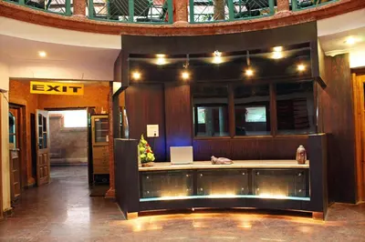 a lobby with a desk with a laptop on it at Parklane Hotel in Mysore