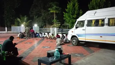 a group of people sitting in front of a van at Ammu's home stay in Panamaram