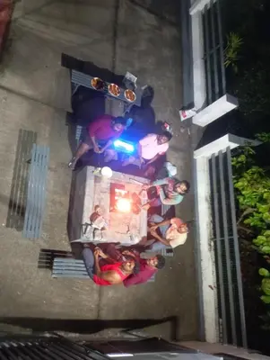 a group of people standing around a table at Ammu's home stay in Panamaram