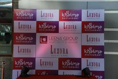 a wall with the names offamousfamous institutions on it at Luxora Hotel and Spa in Kozhikode
