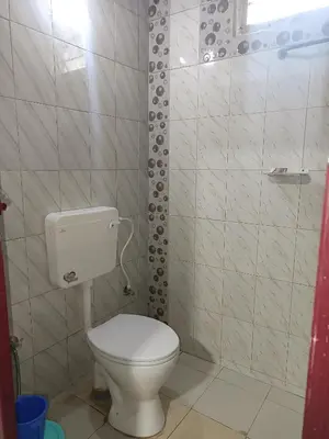 a small bathroom with a toilet and a shower at Osprey individual Cottage in Ooty