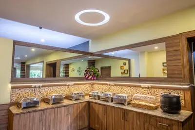 a bar with a row of baskets and a mirror at Vinayaga Inn by Poppys, Ooty in Ooty