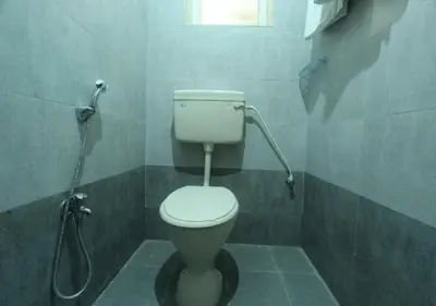 a bathroom with a toilet and a shower at JR Guest Home in Coimbatore