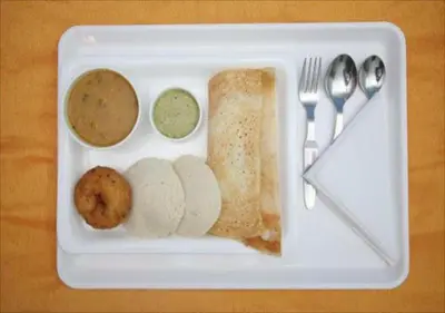 a styrofoam plate with a meal of bread and dips at JR Guest Home in Coimbatore