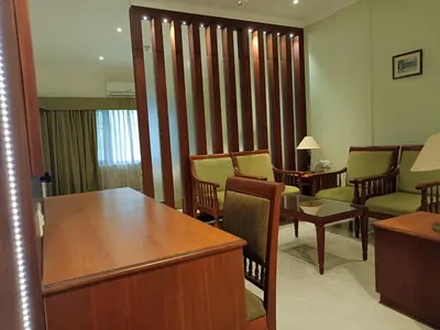 a waiting room with chairs and a table in a room at Hotel CLOUD 9 in Kotamangalam