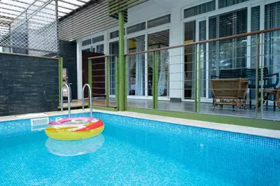a swimming pool with a float in the middle of it at Kuruva Island Resort And Spa - By KABINI BREEZE in Mananthavady
