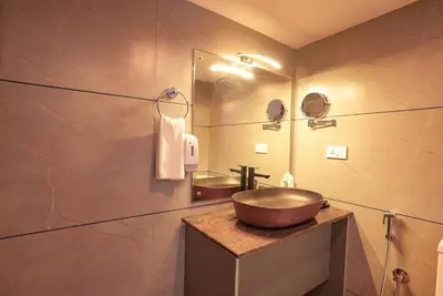 a bathroom with a large bowl sink on a counter at Kuruva Island Resort And Spa - By KABINI BREEZE in Mananthavady