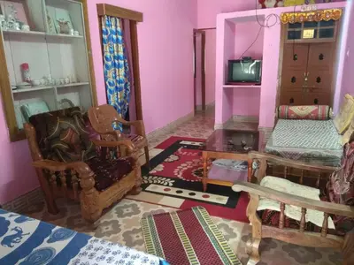 a living room filled with furniture and a tv at Dreams River view Homestay Coorg in Kushālnagar