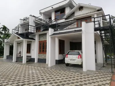 a house with a car parked in front of it at Viewpointwayanad in Mananthavady