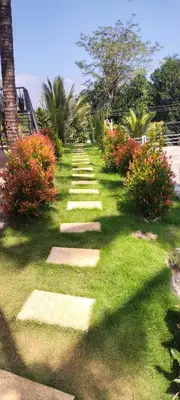 a garden with stepping stones in the grass at Viewpointwayanad in Mananthavady
