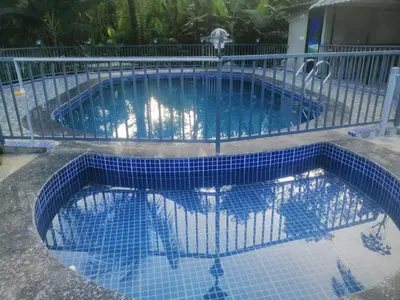 a swimming pool with blue tiles on the ground at Viewpointwayanad in Mananthavady