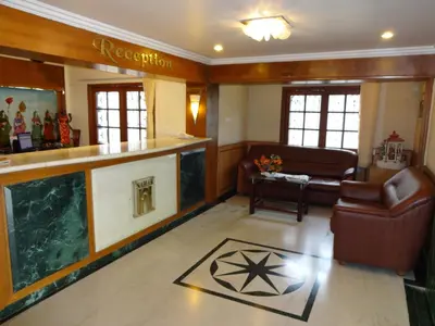 a living room with a bar and a couch at Hotel Nahar Manchester Inn in Coimbatore