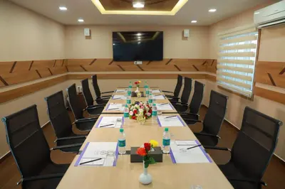 a large conference room with a long table and chairs at Flora Charishma Residency Aluva in Cochin