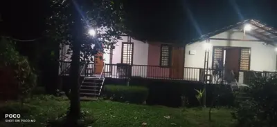 a house at night with a tree in the foreground at Family villa is a hut style accommodation in Tariyod