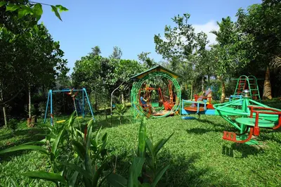 a park with a playground in the grass at Arayal Resort-A Unit of Sharoy Resort in Tariyod