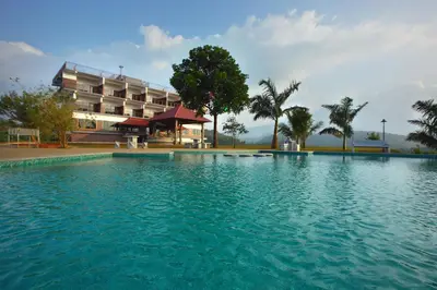 a large swimming pool in front of a hotel at Arayal Resort-A Unit of Sharoy Resort in Tariyod