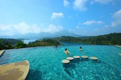 a group of people playing in a pool in the water at Arayal Resort-A Unit of Sharoy Resort in Tariyod