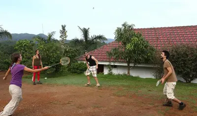 a group of people playing a game of tennis at Arayal Resort-A Unit of Sharoy Resort in Tariyod