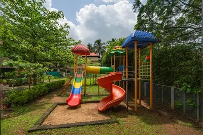 a playground with a slide and a slideintend at Sterling Govardhana Malampuzha in Palakkad